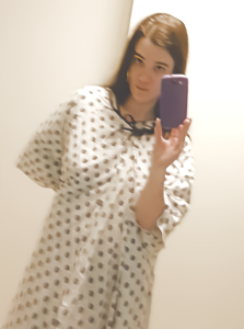 Mirror selfie wearing double hospital gowns